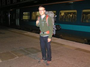 Man in hiking gear with heavy backpack